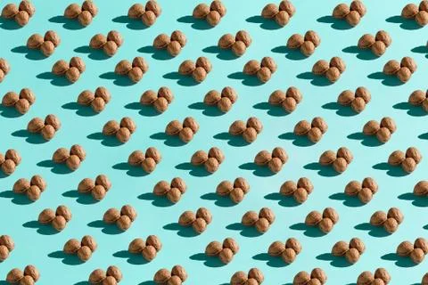 Background made from walnuts on the blue background Stock Photos