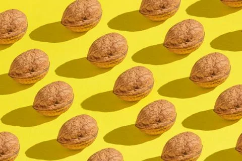 Background made from walnuts on the yellow background Stock Photos