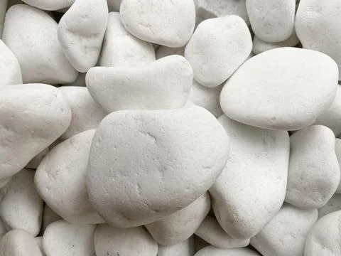 The background is made of white smooth pebbles of white color. Textured pebbles Stock Photos