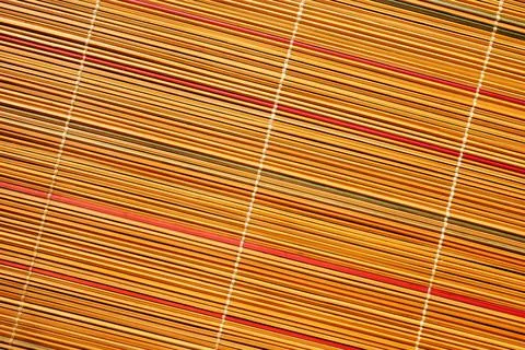 The background is made of woven rods. Stock Photos
