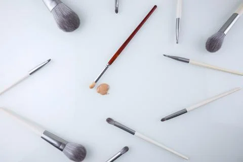 Background of makeup brushes and a drop of Foundation for the face Stock Photos