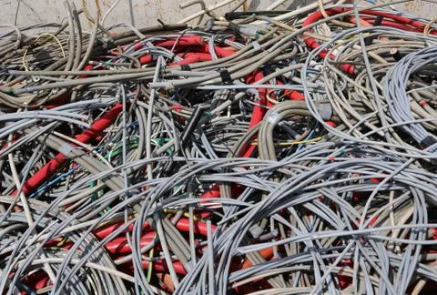 Background of many abandoned electrical cables in a dump of recyclable materi Stock Photos