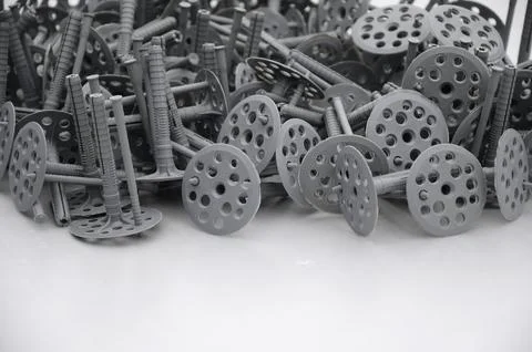 Background of many gray plastic dowels fastening for thermal insulation. A .. Stock Photos