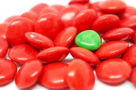 Background many red and one green candy Stock Photos