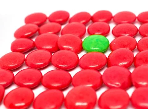 Background many red and one green candy Stock Photos