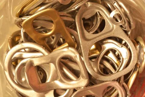 Background of many ring pull can opener, silver and gold. Stock Photos