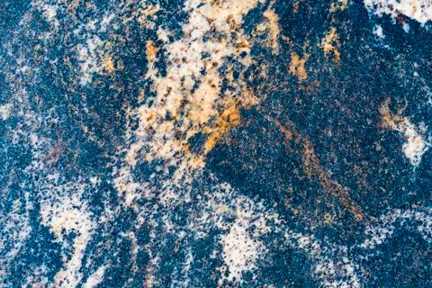 Background of a marble slab with a natural pattern. Color blue, white, yellow. Stock Photos