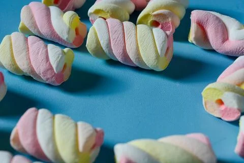 Background with marshmallow on a blue background. Stock Photos