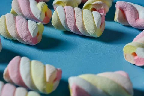 Background with marshmallow on a blue background. Stock Photos