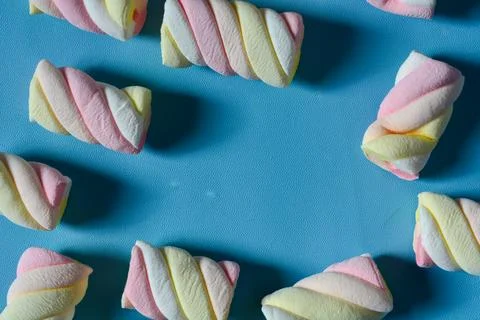 Background with marshmallow on a blue background. Stock Photos