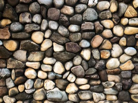 Background of masonry round stones on the surface Stock Photos