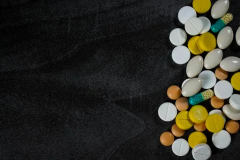 Background of medical tablets on a dark table Stock Photos
