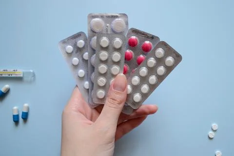 Background for a medical website or article, packs of pills in hand, capsul.. Stock Photos