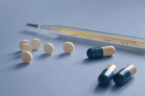 Background for a medical website or article, pills, capsules and mercury th.. Stock Photos