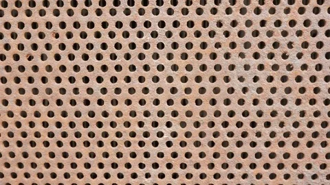 Background Metal rusty old car grille. Symmetric holes on the entire surface of Stock Footage 76974417