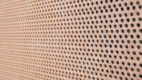 Background Metal rusty old car grille. Symmetric holes on the entire surface of Stock Footage 76975264