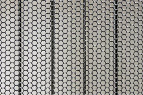 Background of the metal surface of the grid with uniform round holes and line Stock Photos