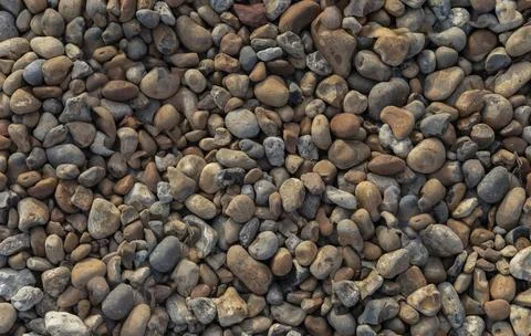 Background of mixed pebbles which are orange blue and grey Stock Photos
