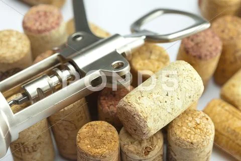 Background of the mountains of wine corks and a corkscrew Stock Photos