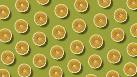Background of moving lemon halves on a green background Stock Footage 246965511