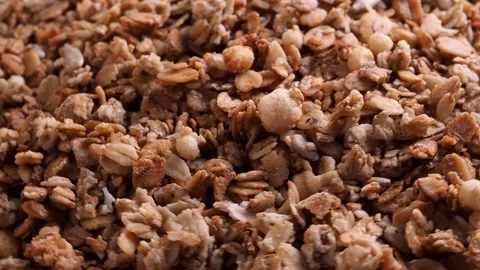 Background muesli oat flakes nuts and raisins, rotation. The concept of healthy  Video stock 264947576
