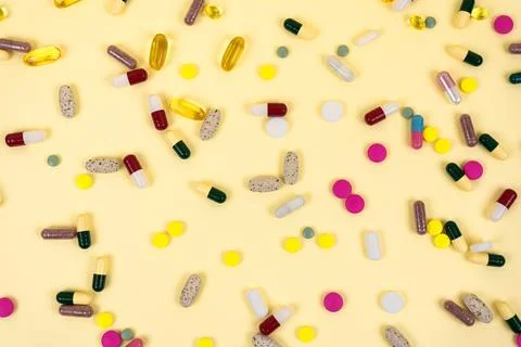 Background from multi-colore pills and capsules. Stock Photos