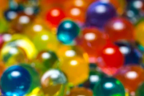 Background of multi-colored, blurry, wet hydrogel balls Stock Photos