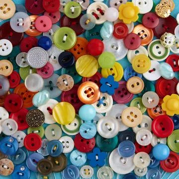 Background from multi-colored clothes buttons. Background for needlework Stock Photos
