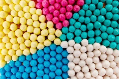 Background of multi-colored cotton swabs, sticks, buds. Macro shot. Stock Photos
