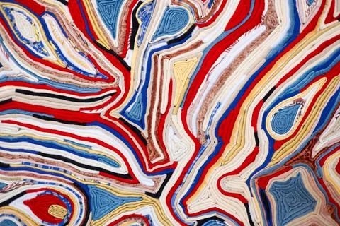 Background of multi-colored fabric tightly folded together. Clothes tightly Stock Photos