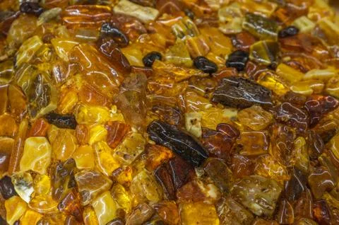 Background of multi-colored pieces of amber, selective focus Stock Photos