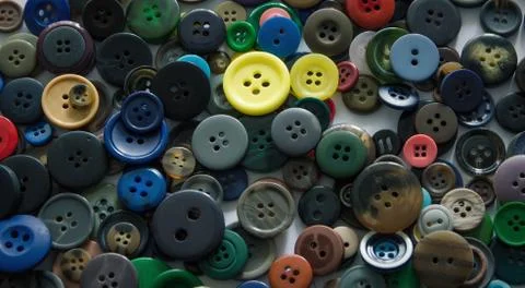 Background from multi-colored randomly scattered buttons. Stock Photos