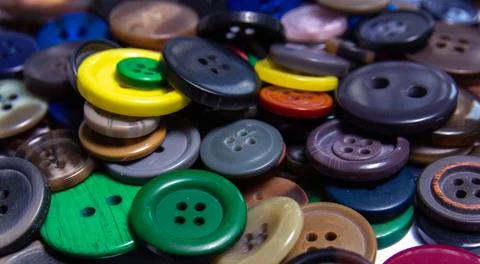 Background from multi-colored randomly scattered buttons. Stock Photos