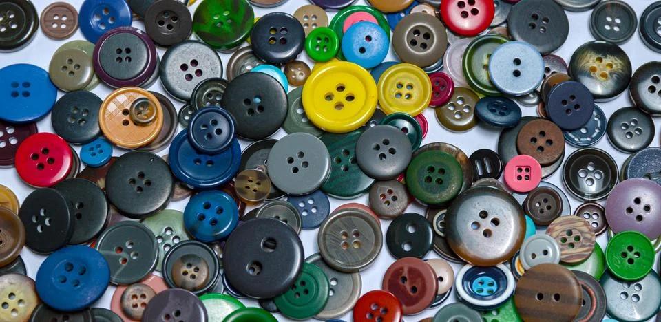 Background from multi-colored randomly scattered buttons. Stock Photos