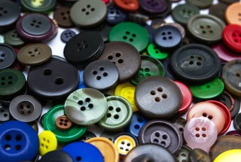 Background from multi-colored randomly scattered buttons. Stock Photos