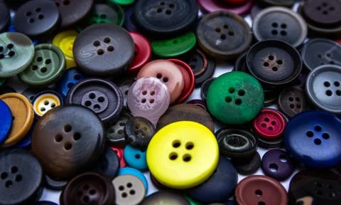 Background from multi-colored randomly scattered buttons. Stock Photos