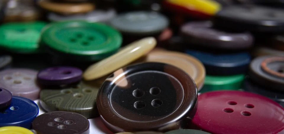 Background from multi-colored randomly scattered buttons. Stock Photos