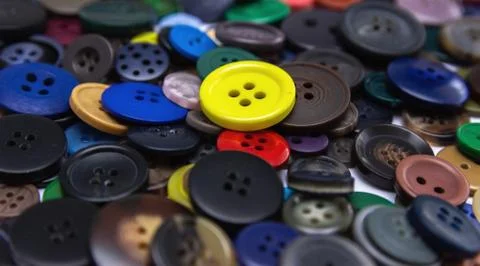 Background from multi-colored randomly scattered buttons. Stock Photos