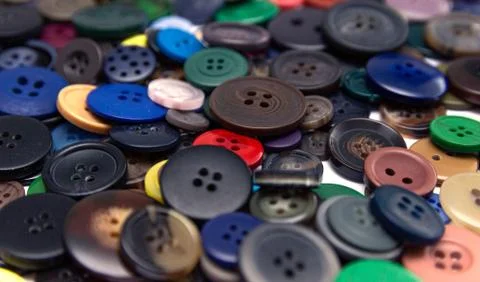 Background from multi-colored randomly scattered buttons. Stock Photos