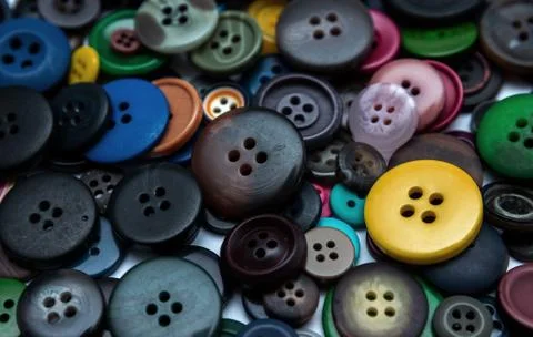 Background from multi-colored randomly scattered buttons. Stock Photos