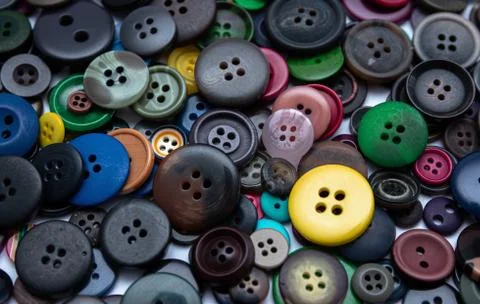 Background from multi-colored randomly scattered buttons. Stock Photos