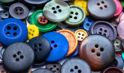 Background from multi-colored randomly scattered buttons. Stock Photos