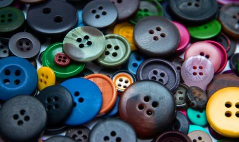 Background from multi-colored randomly scattered buttons. Stock Photos