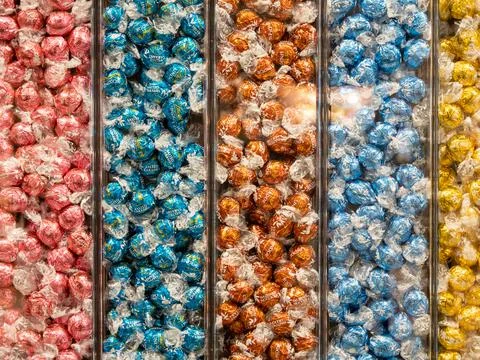 Background from multi-colored sweets. Sweets sorted by color. Stock Photos