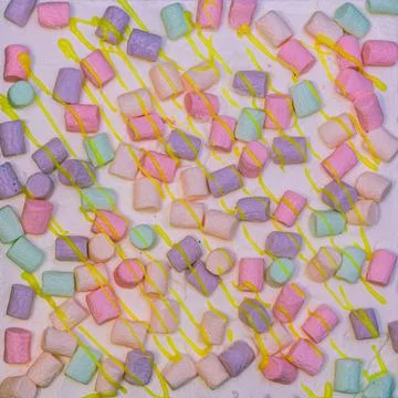 Background of multicolor four layer cake with colored marshmallow on the top Stock Photos