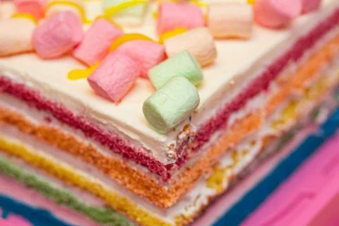 Background of multicolor four layer cake with colored marshmallow on the top Stock Photos