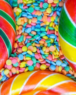 Background from multicolored assortment of delicious candy and confetti top v Stock Photos