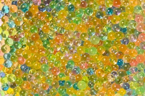 Background of multicolored balls. Expandable water toy orbiz. Stock Photos