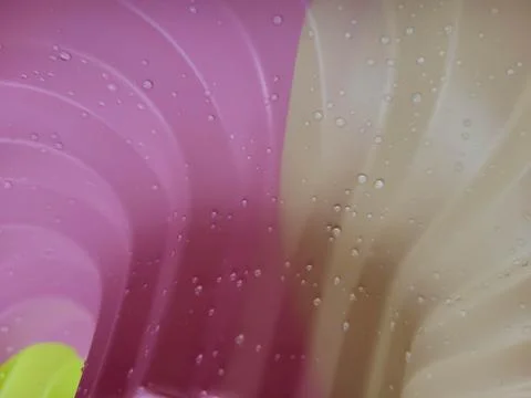 Background multicolored silicone baking pan from water droplets. Stock Photos