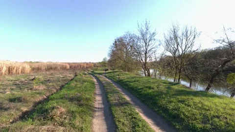 Background of natural landscape, walking along a field and a river in spring Stock Footage 320558841